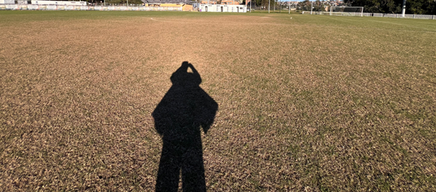 A shadow of a person on a field

AI-generated content may be incorrect.